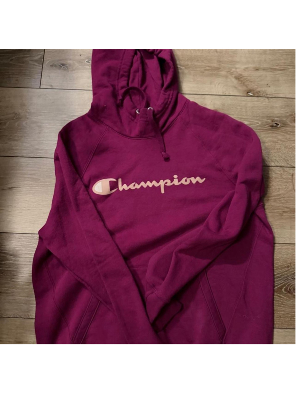 Champion berry magenta logo hoodie with oversized cream script graphic across th